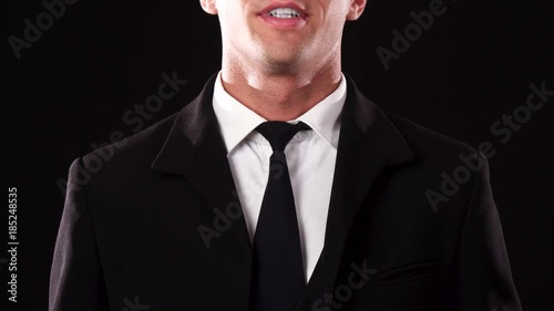 Close-up of the hands of a guy who straightens his tie