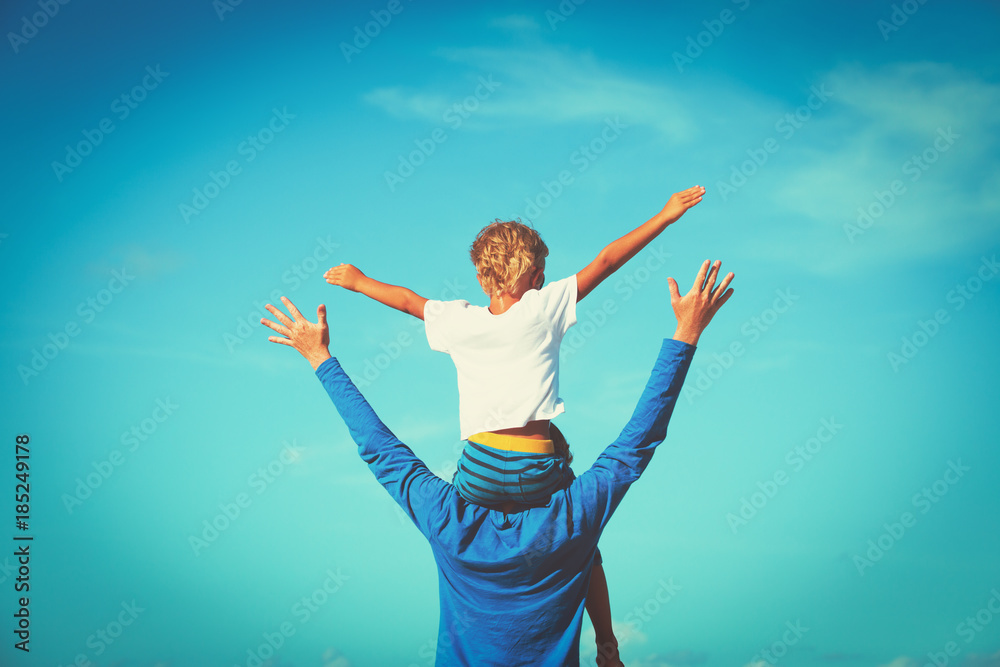 father and son having fun on sky