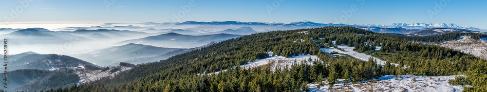 Fototapeta premium Panorama of winter High Tatras and many small hills in mist - view from Skalisko