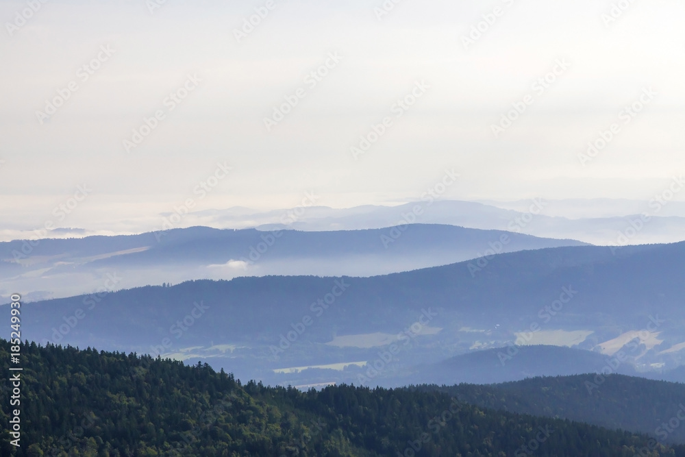 Morning landscape in haze in National park Bayerische Wald,
view from the mountain Grosser Arber, Germany. Morning landscape in haze in National park Bayerische Wald,
view from the mountain Grosser Arber, Germany.