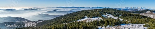 Panorama of winter High Tatras and many small hills in mist - view from Skalisko