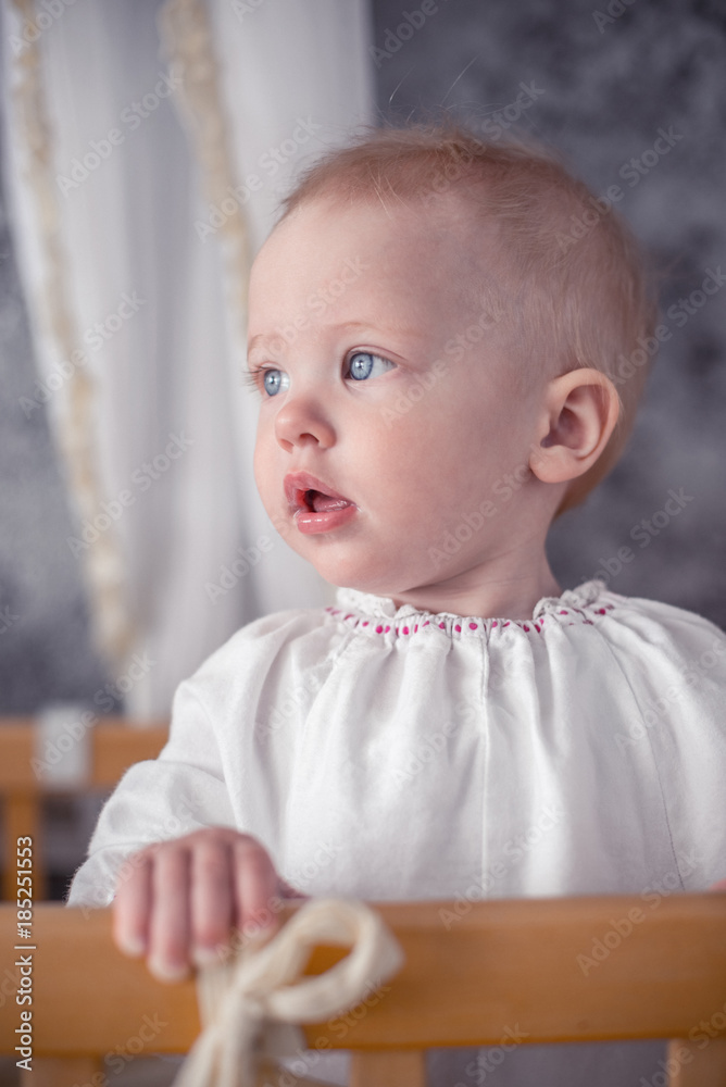 Cute little baby standing in crib at home Cute little baby standing in crib at home