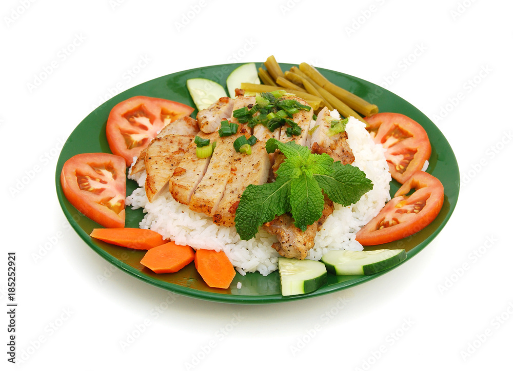 A baked pork chop with rice and cucumber, tomatoe