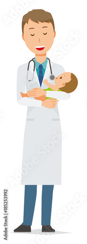 A young male doctor in a white garment holds a baby