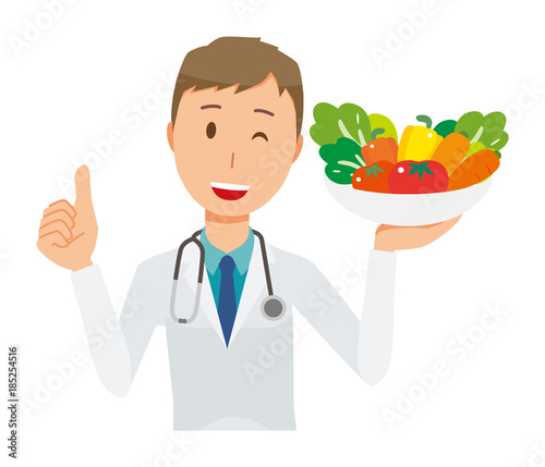 A young male doctor wearing a white suit has vegetables