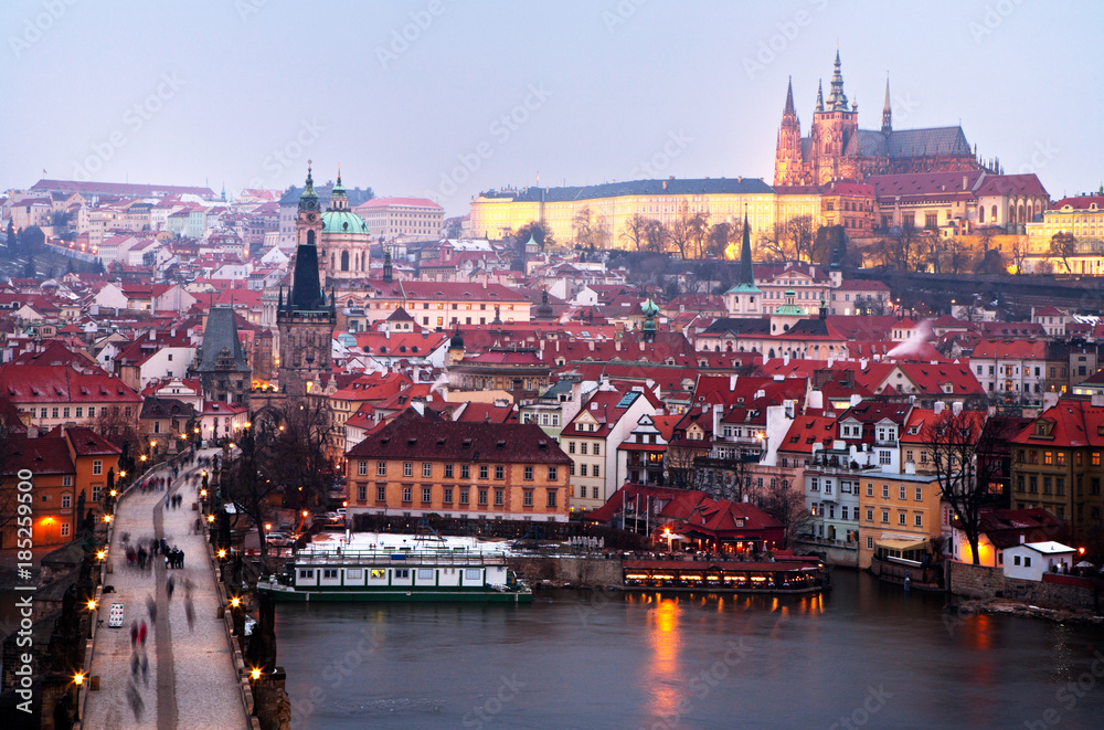 A view from above on the center of Prague and Charles Bridge on a winter evening. Beautiful city landscape