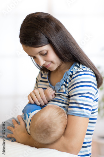 Young woman breast feeding ...