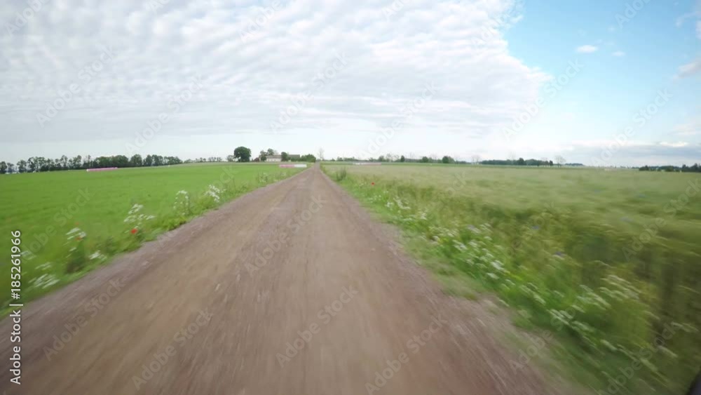 Riding bike on rural road in sunshine. Summer leisure activity in pov perspective. Riding bike on rural road in sunshine. Summer leisure activity in pov perspective.