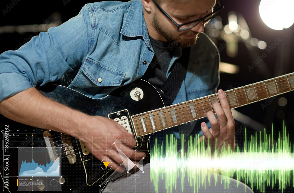 Obraz premium close up of musician playing guitar at studio