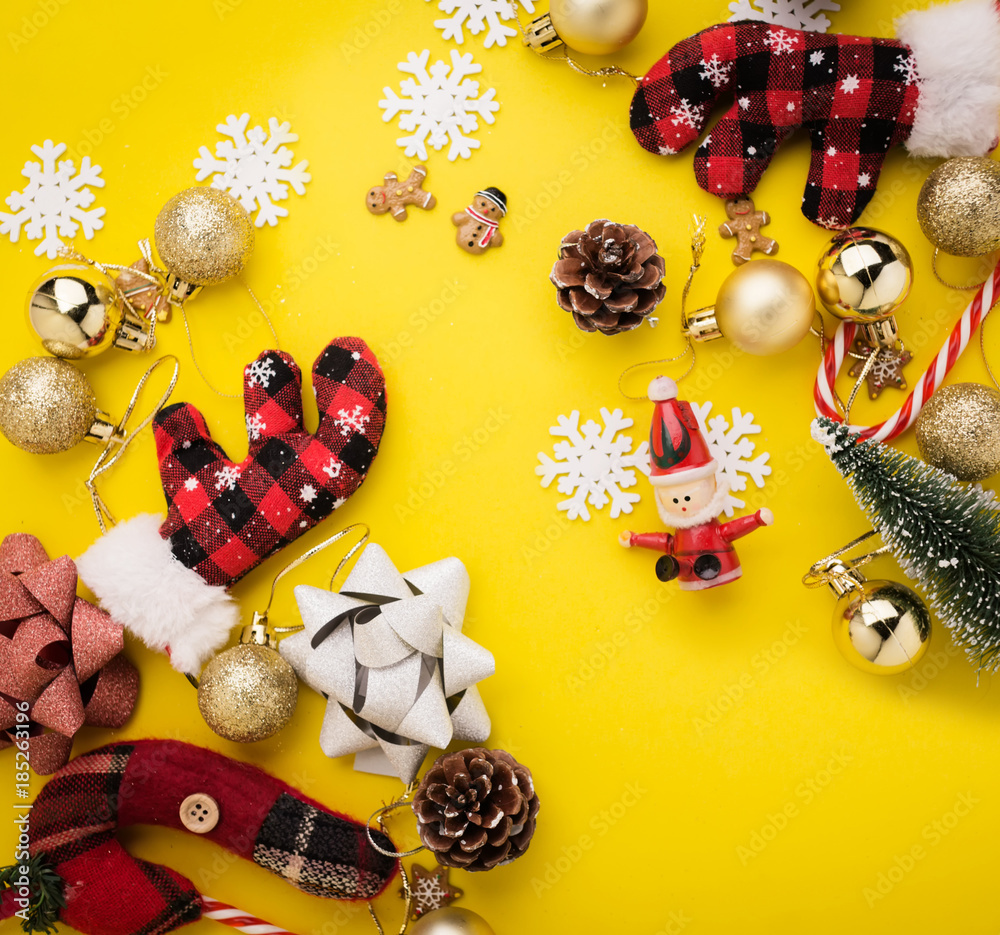 christmas and new year ideas concept with festive decorating items on yellow color plate background with free copy space for your creativity ideas text christmas and new year ideas concept with festive decorating items on yellow color plate background with free copy space for your creativity ideas text