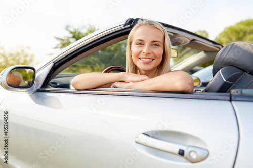 happy young woman in convertible car
