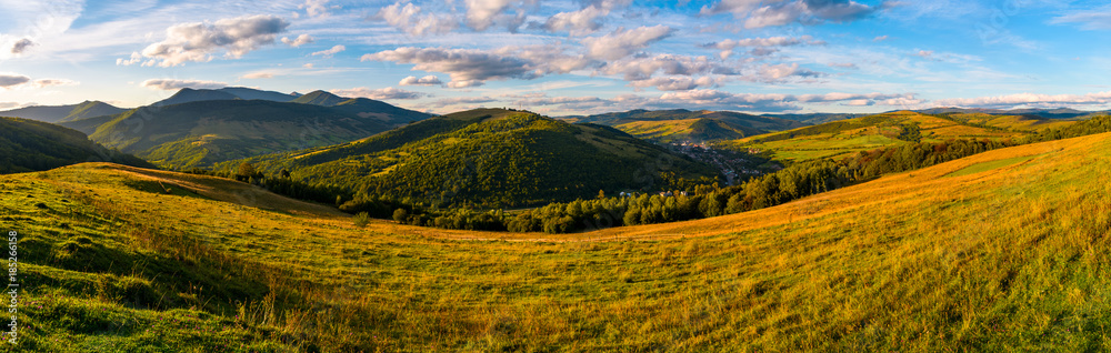 agricultural field in mountainous countryside. old fashioned rural economy concept. gorgeous landscape of Carpathians at sunset with cloudy sky agricultural field in mountainous countryside. old fashioned rural economy concept. gorgeous landscape of Carpathians at sunset with cloudy sky