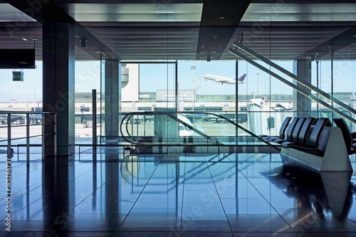 Airport departure lounge seating and escalators