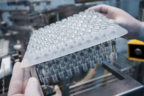 set of test tubes close-up in laboratory assistant hands 
