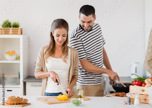 couple cooking food at home kitchen