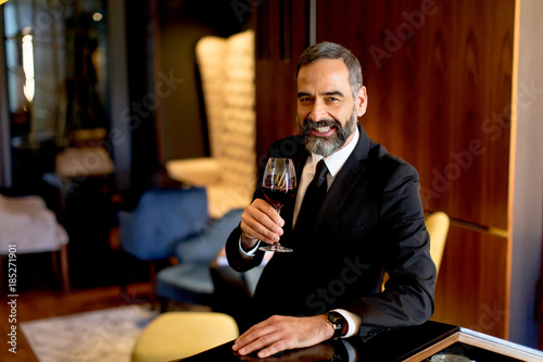 Handsome mature man tasting...