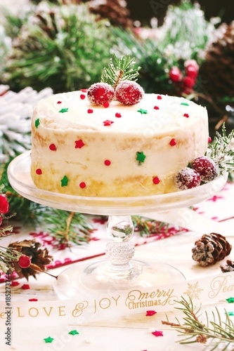 Homemade Naked white Christmas cake on festive holiday background, selective focus