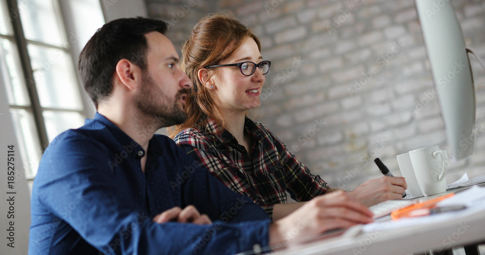 Portrait of young designers working on computer