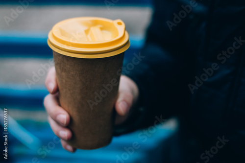 A paper hot coffee cup in male hand