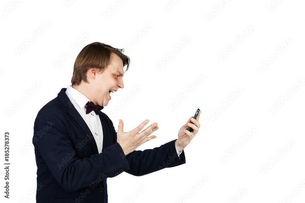 Half length portrait of a young man in gray suit shouting and going mad talking to boss on mobile phone Half length portrait of a young man in gray suit shouting and going mad talking to boss on mobile phone