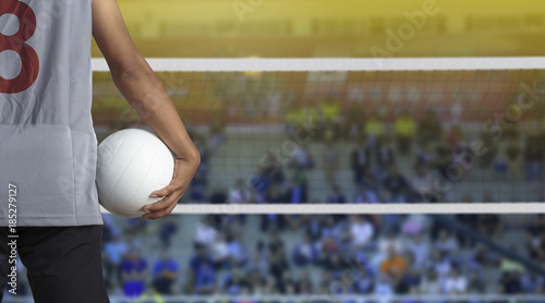 Volleyball player with ball on volleyball court