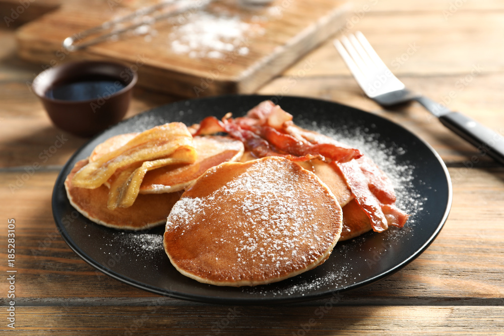 Tasty pancakes with bacon and banana on table Tasty pancakes with bacon and banana on table