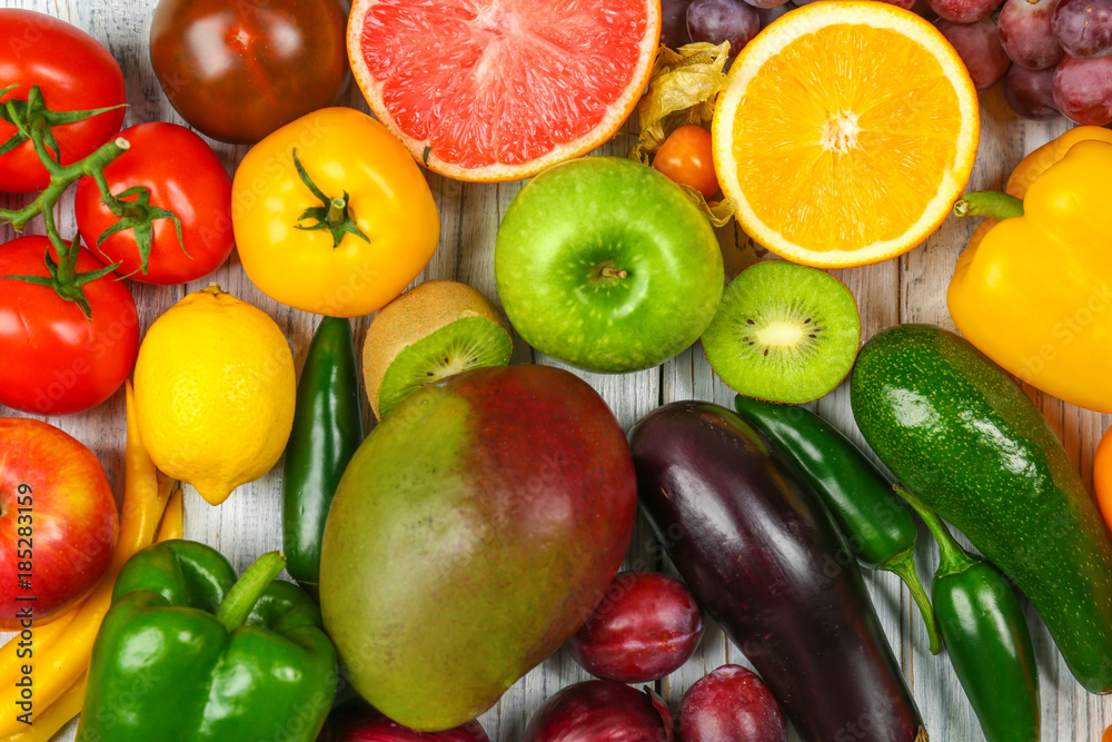 Creative composition made of fruits and vegetables in rainbow colors on wooden background, flat lay Creative composition made of fruits and vegetables in rainbow colors on wooden background, flat lay