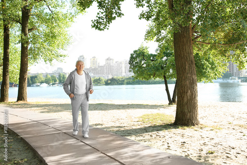 Mature man running near river
