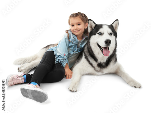 Little girl with cute Husky dog on white background