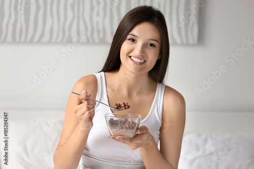 Young woman having breakfas...