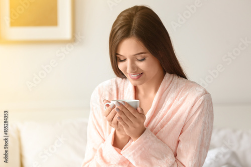 Young woman drinking coffee...