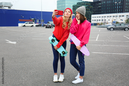 Two happy hipster girls wit...