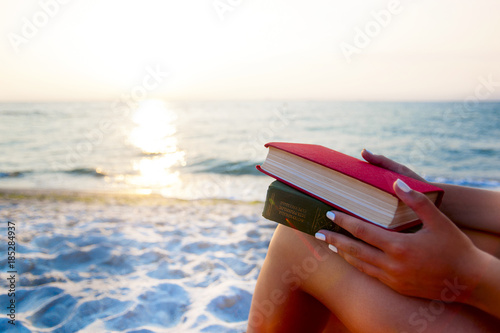 Woman reading book relaxed in deck chair