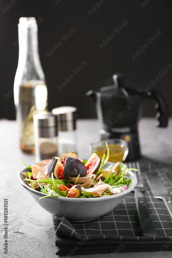 Bowl with delicious fresh salad on table