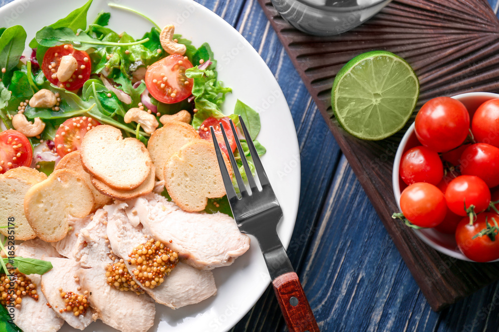 Plate with meat and delicious fresh salad on table Plate with meat and delicious fresh salad on table