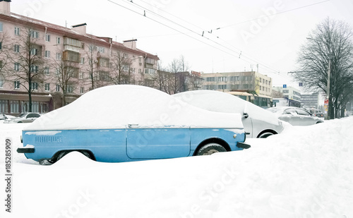 Snow on cars after snowfall. Winter urban scene © V-lab