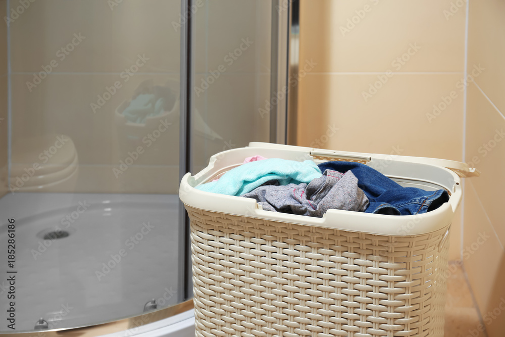 Basket with dirty laundry in bathroom Basket with dirty laundry in bathroom
