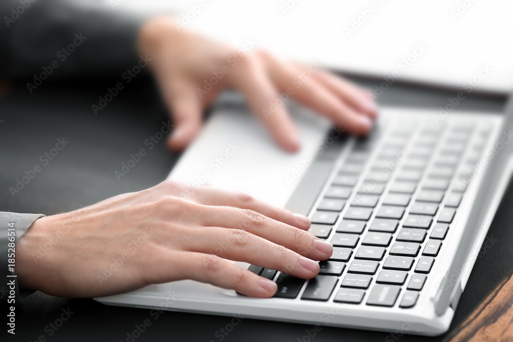 Young notary working with laptop, closeup