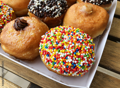 Fresh donuts on bakery display for Hanukkah celebration.  photo