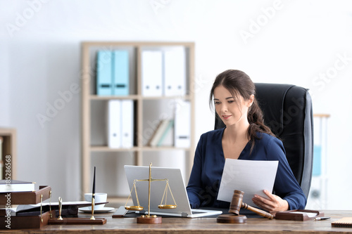 Photographie Young female notary working in office