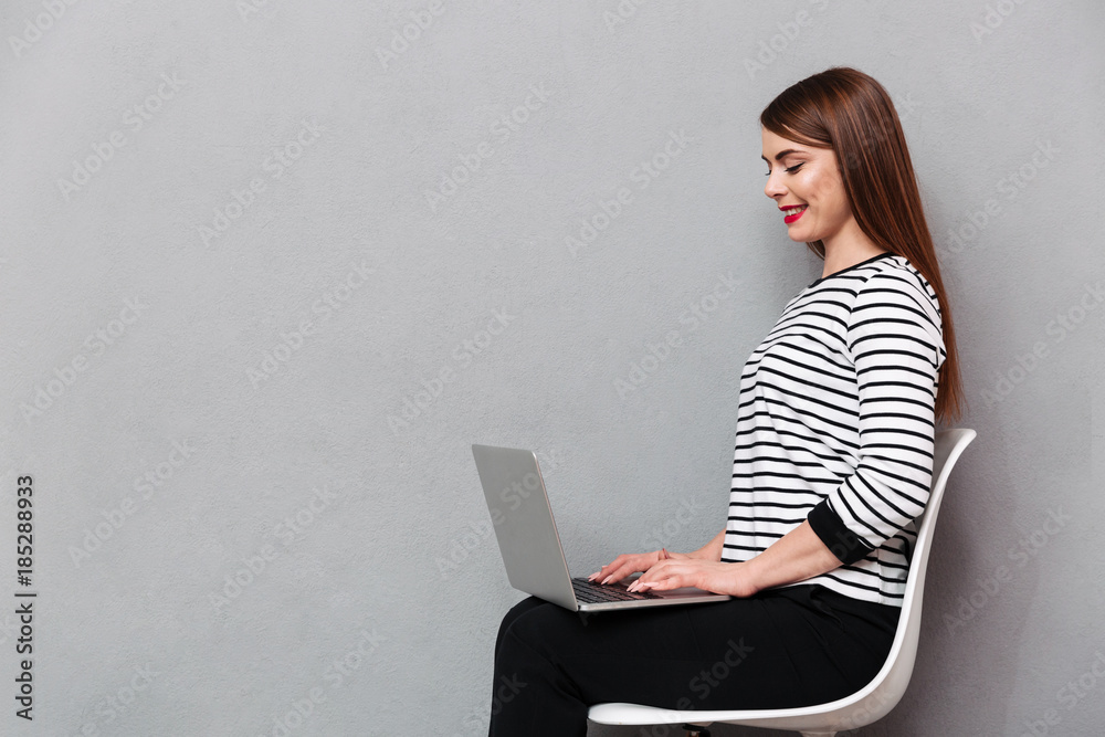 Fototapeta premium Portrait of a happy woman sitting on chair