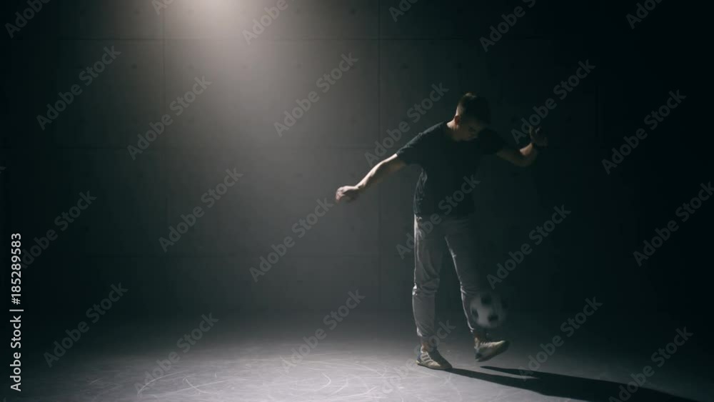 Football freestyle. Young man practices with soccer ball Football freestyle. Young man practices with soccer ball