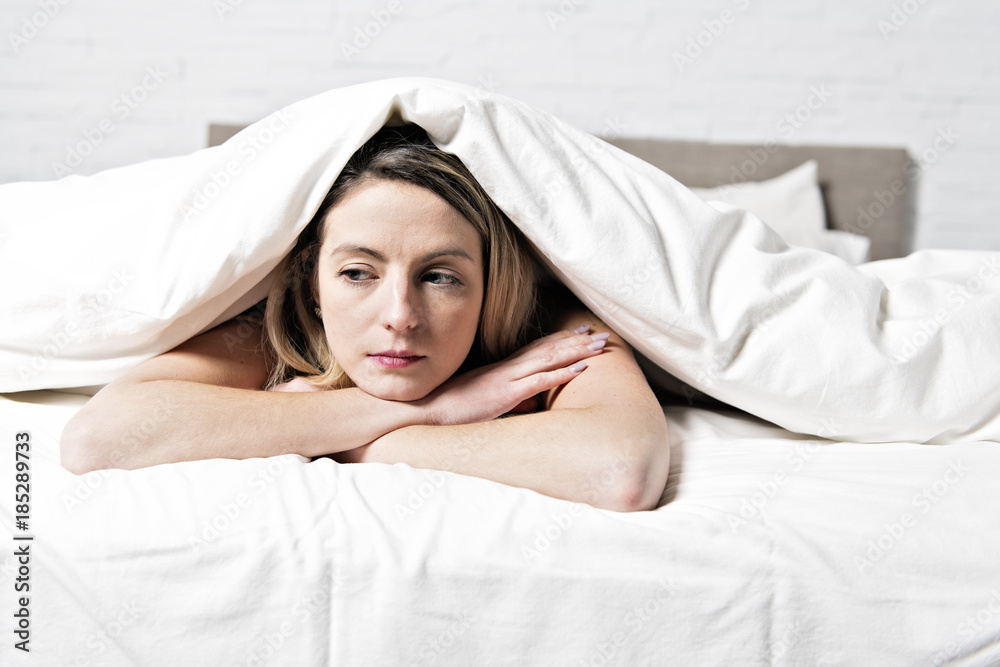 Sad mature female in bed at bedroom Sad mature female in bed at bedroom