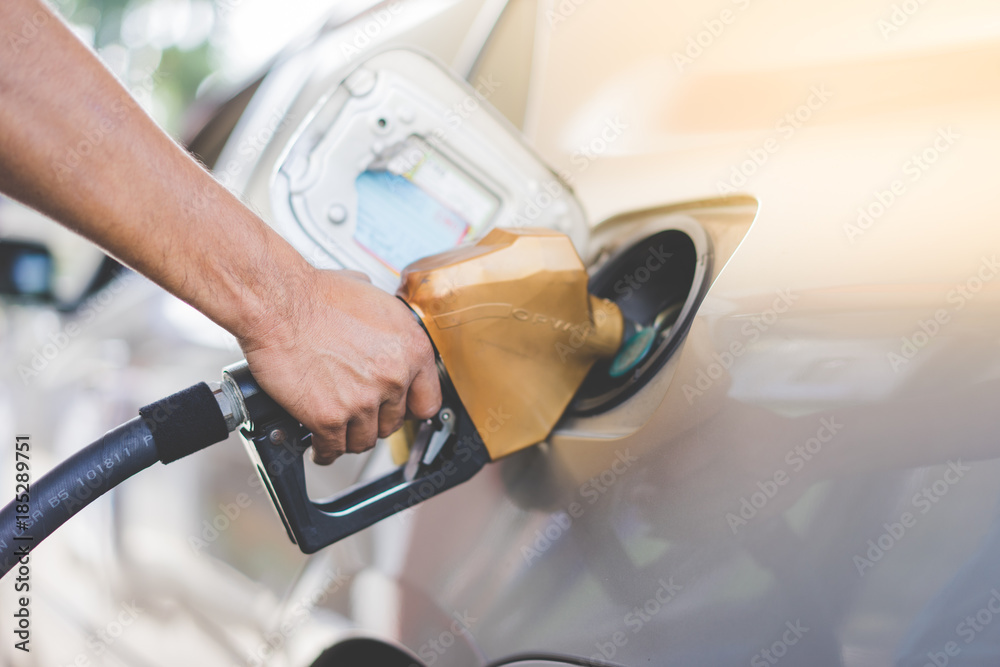 Car refueling on petrol station. Fuel pump with gasoline. This photo can be used for fuel industry or transportation concept. Car refueling on petrol station. Fuel pump with gasoline. This photo can be used for fuel industry or transportation concept.
