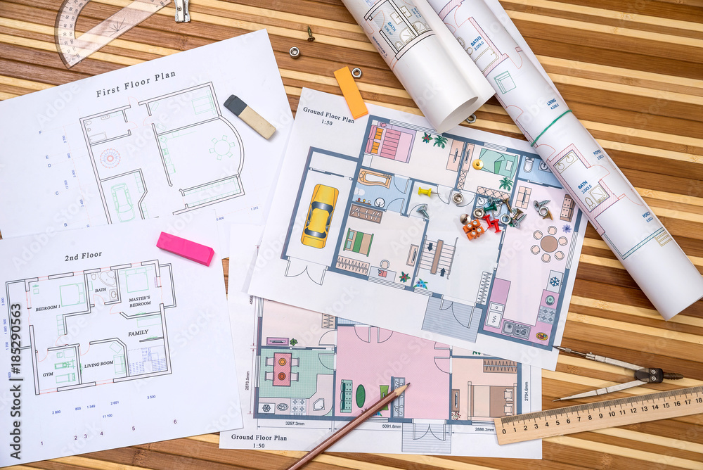 Fototapeta premium plan of apartment rooms and blueprint rolls with work tolls