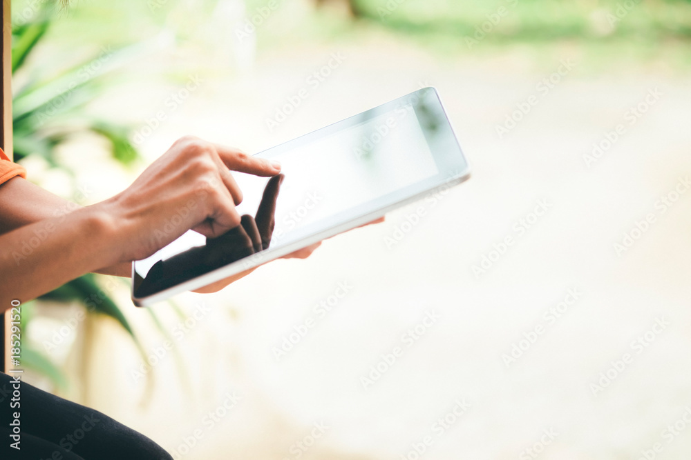 Woman using tablet for working and learning.
