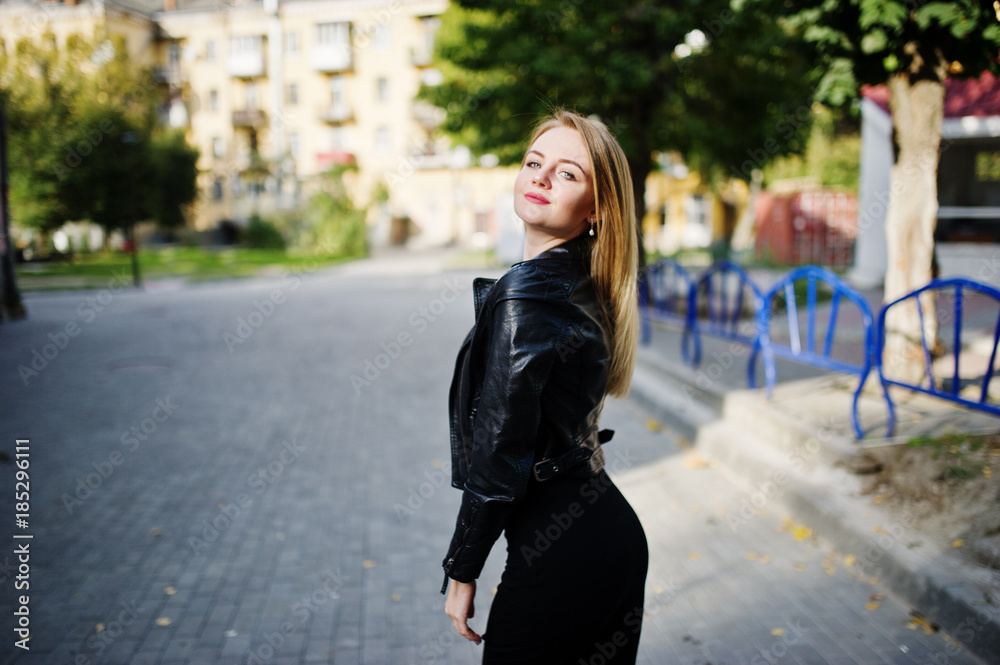 Elegant blonde girl wear on black leather jacket posing at streets of town. Elegant blonde girl wear on black leather jacket posing at streets of town.