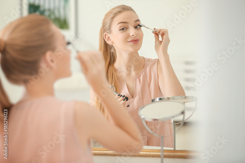 Beautiful young woman using...