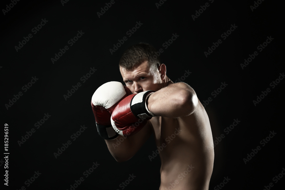 Attractive young boxer on black background Attractive young boxer on black background