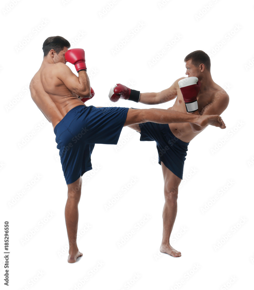 Attractive young kickboxers fighting on white background Attractive young kickboxers fighting on white background